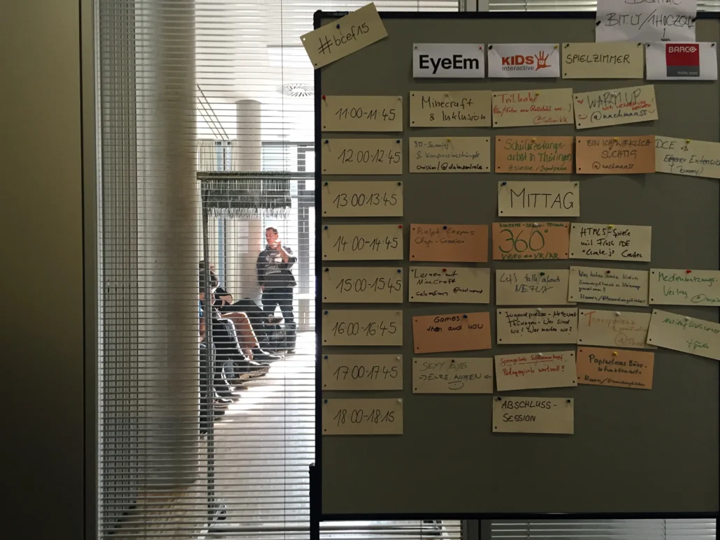 A group of professionals, including Piers Hedley, Chris Justice, and Clare Walsh, gathered around a table, discussing business strategies and growth plans.