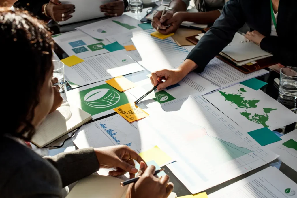 A collaborative team discussing and working together on an ESG project, highlighting the importance of employee engagement in achieving successful sustainability outcomes.